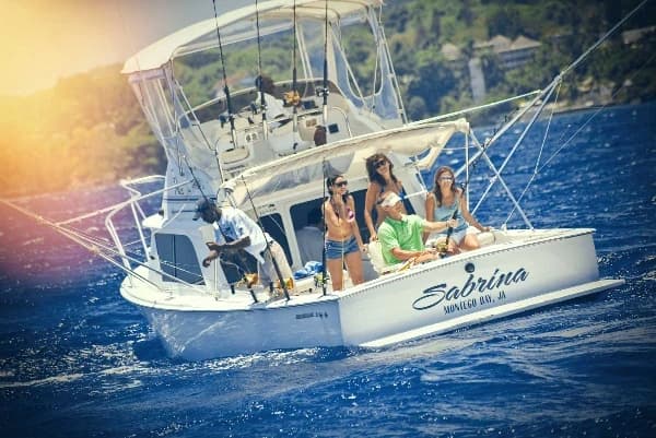 A fishing boat with smiling people fishing